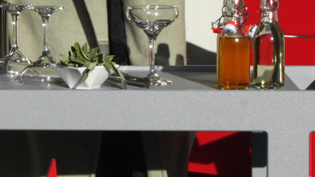 Image: Woman holding a stainless steel shaker. She is making a cocktail outside on the Lollygagger Bar Cart.