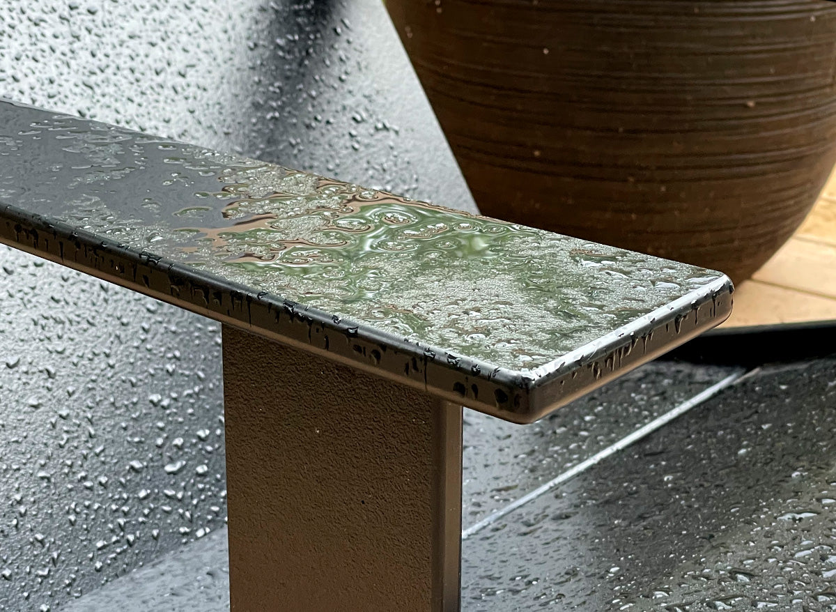 detailed close up image of a chair arm in the rain