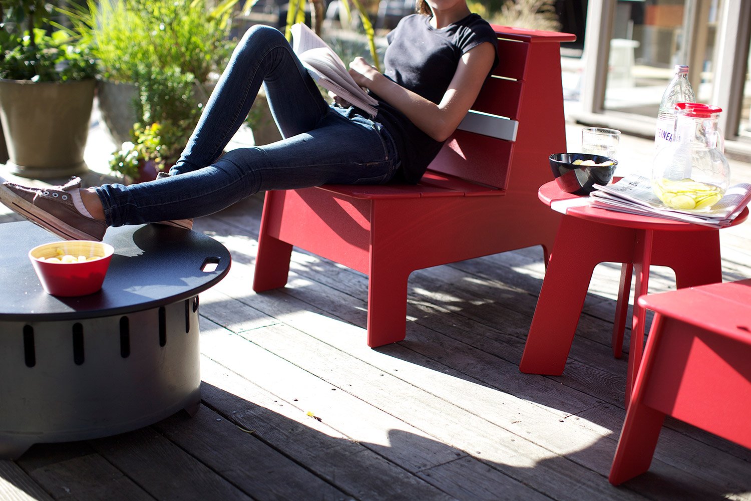 person using fire ring top on deck with pfeiffer racer outdoor lounge chair 
