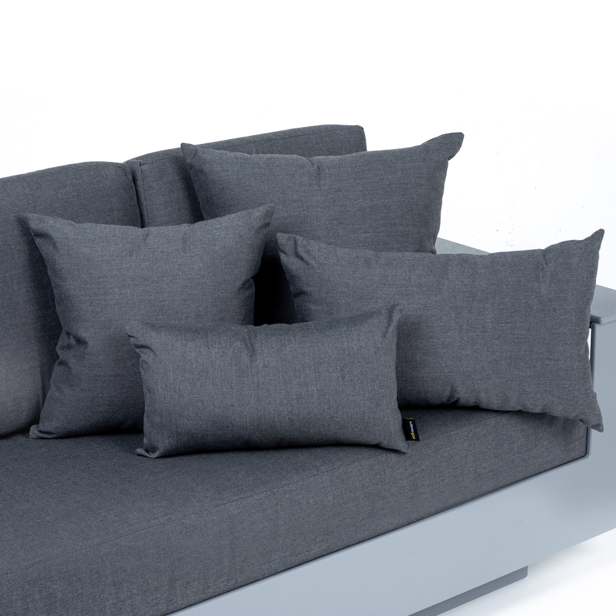 studio image of small square, large square, small rectangle, and large rectangle pillows in charcoal on a nisswa sofa with charcoal cushions.