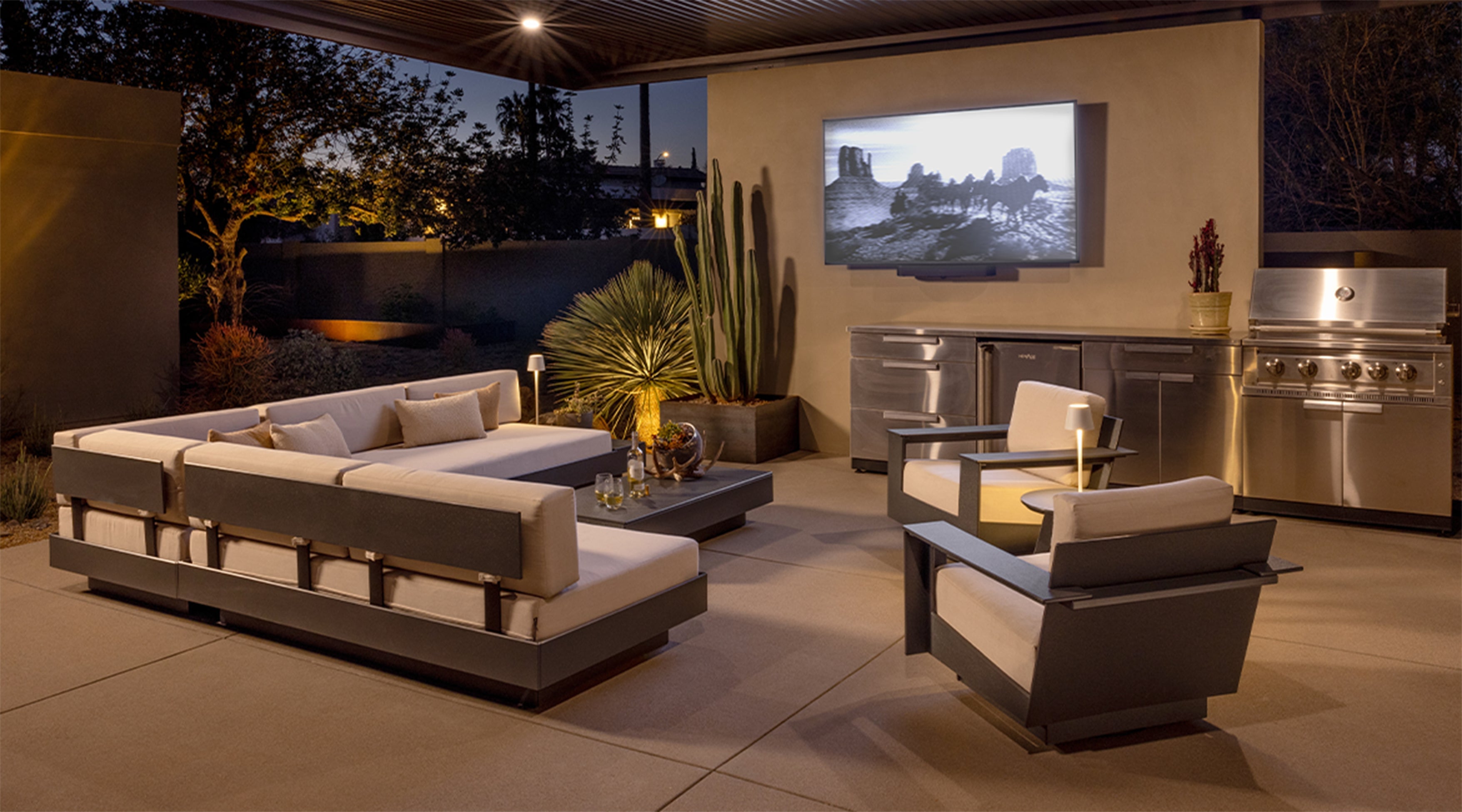 A Platform One sofa setup with a Platform One Coffee Table and two Nisswa Swivel lounge chairs in a covered outdoor seating area.