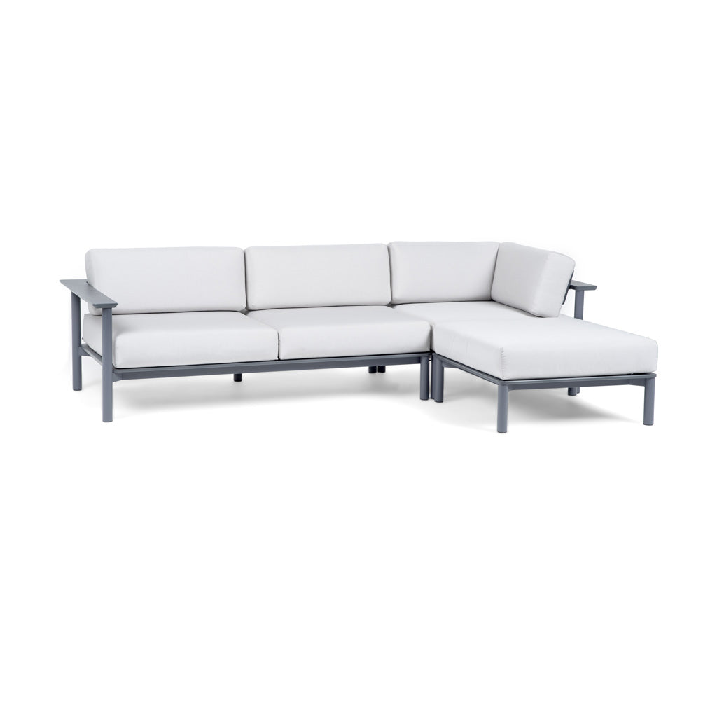Front View: Aurora configuration set up in an "L" with a Right Arm Sofa, Corner Lounge, and Ottoman with Charcoal frame and Cloud cushions. 