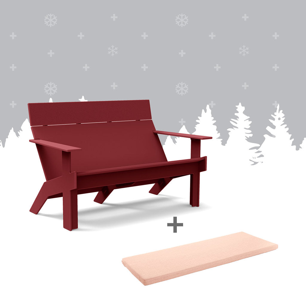 Tall chili lollygagger sofa and a petal sofa cushion against grey forest background.