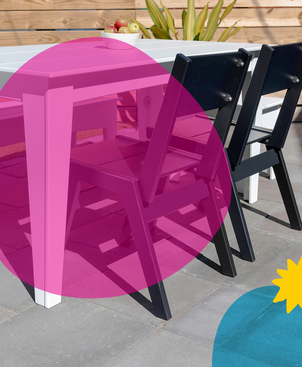 image of white alfresco table with black chairs on patio. a large pink circle is over the left side of image, with a blue circle and yellow star in lower right. 