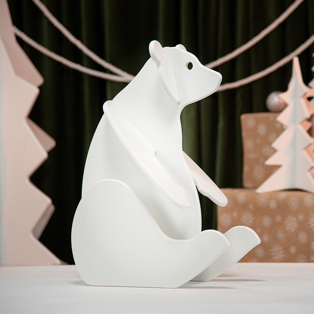 White polar bear decorative light on a table with a festive background