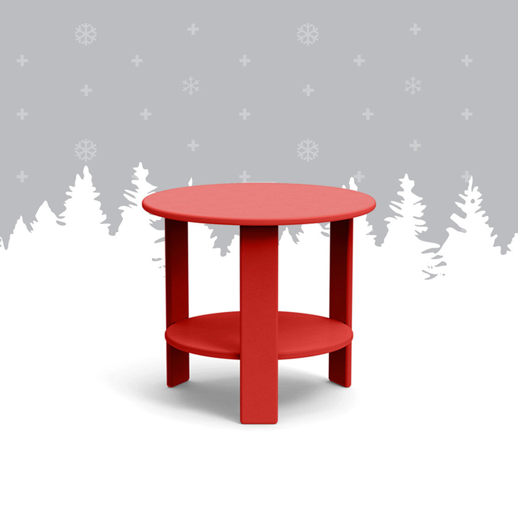 apple red lollygagger side table against grey forest background. 