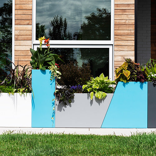 Modern outdoor setting with colorful planters in front of a building
